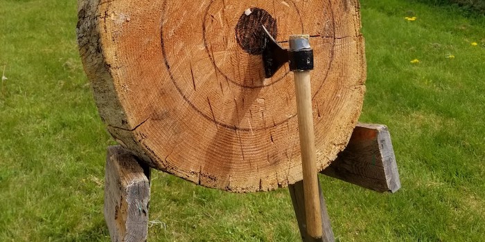An axe stuck in a target.